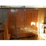 An Edwardian mahogany and line inlaid breakfront wardrobe/linen press having dentil moulded cornice,