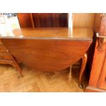 A Georgian style mahogany oval top drop flap dining table,