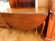 A Georgian style mahogany oval top drop flap dining table,