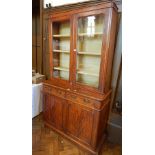 A Victorian mahogany glazed bookcase with pair panel doors enclosing three shelves,