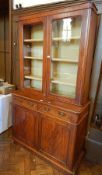 A Victorian mahogany glazed bookcase with pair panel doors enclosing three shelves,