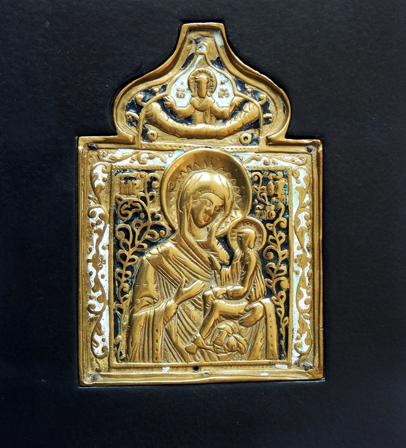 Russian brass and enamel champleve icon, the holy mother and child beneath ogee arch, in black