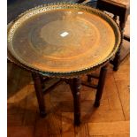 Indian brass occasional table with tray top, decorated with Arabic writing and pierced edge,