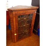 George III mahogany inlaid corner cupboard, with serpentine shelves, glazed door,