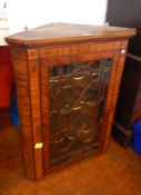 George III mahogany inlaid corner cupboard, with serpentine shelves, glazed door,