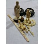 Three Japanese carved ivory male figures and chopsticks with stands