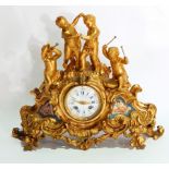 Late 19th century gilt metal mantel clock depicting putti playing instruments and dancing on rocky