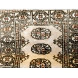 Rug with white ground, black and red decoration,