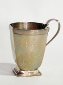 George V silver Christening mug of faceted form, raised on a square foot, Sheffield 1934,