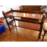 A Victorian mahogany two-tier buffet trolley with foliate carved and baluster supports, on castors,