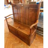 Antique oak settle with triple framed fielded panels to the back, open arms,