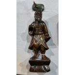 A Japanese hardwood figure of a man in traditional clothes,