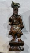 A Japanese hardwood figure of a man in traditional clothes,