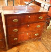 A mahogany small chest of drawers with three graduated drawers, ivory shield escutcheons,