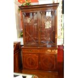 An Edwardian inlaid mahogany library bookcase with egg and dart and ovolo frieze, shelved and glazed