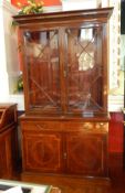 An Edwardian inlaid mahogany library bookcase with egg and dart and ovolo frieze, shelved and glazed