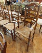 Harlequin set of seven oak ladderback dining chairs with rush seats,