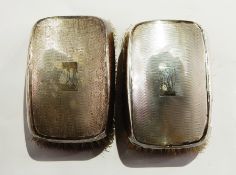 Pair of George VI gentleman's silver-backed hairbrushes of engine-turned design,