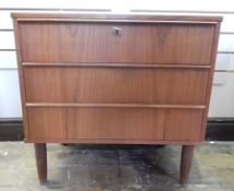 1960's Danish teak chest of three long drawers with long bar handles to the top edge of each drawer,
