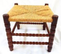 Ernest Gimson yew rush-seated stool made by Edward Gardiner on bobbin turned supports and cross