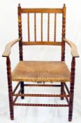 Ernest Gimson yew rush-seated armchair made by Edward Gardiner with two pointed finials to the