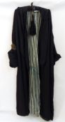 A black silk evening coat bearing the label Elise Kreutzer, lined with green and black striped silk,