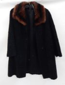 An vintage black astrakhan coat with a musquash collar  Live Bidding: If you would like a