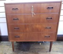 1960's Danish teak chest of four long drawers with inset handles, on turned tapering supports,