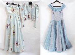 A 1950's silk evening dress with matching jacket, full petticoat and skirt with the base of the