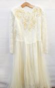 A cream lace wedding dress applied sequins and lace to the bodice,