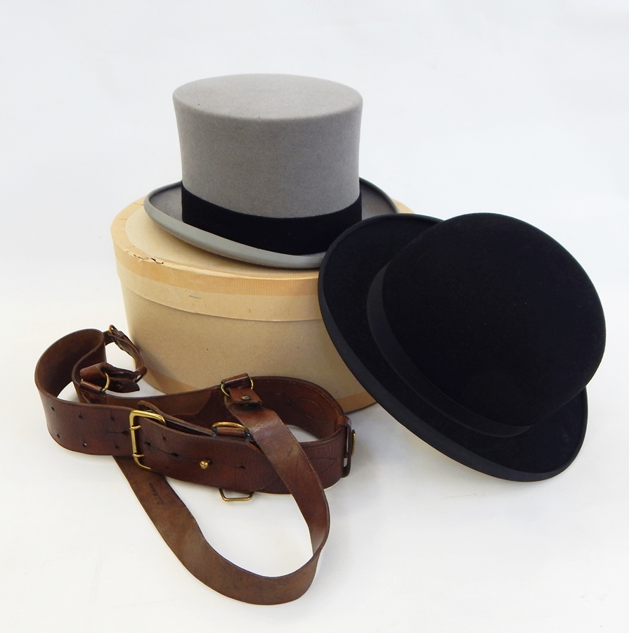 A grey top hat by Christys' London, size 71/8, a bowler hat, a leather belt with brass fittings