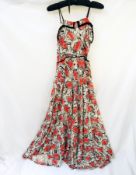 A 1940's linen evening dress printed with a bold pattern, in red and black,