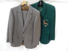 A vintage grey suit, a tweed vintage gentleman's suit, a V-neck cricket sweater,