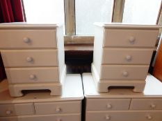 A pair of white painted three drawer bedside chests,
