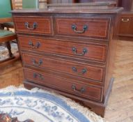 Reproduction mahogany chest of two short and three long graduated drawers raised on bracket feet,