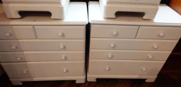 A pair of Sheredon white painted chests on two short and three long graduated drawers on bracket