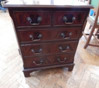 Reproduction mahogany chest of two short and three long graduated drawers on bracket feet,