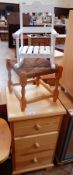 A small pine chest of three graduating drawers, with turned bun handles, on shaped bracket feet,