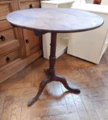 19th century oak circular top tripod table, on turned column supports with splayed legs,