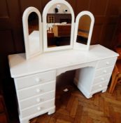 A Sheredon white painted kneehole dressing table of eight short drawers, with open drawer,