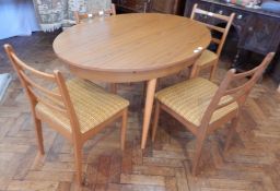 A Schreiber furniture open top dining table, on turned tapering circular legs, length 137cm,