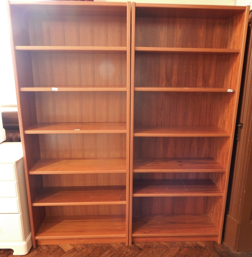 A pair of modern hardwood open shelf bookcases with adjustable shelves,