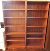 A pair of modern hardwood open shelf bookcases with adjustable shelves,