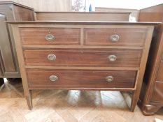 An Edwardian mahogany chest of drawers on square tapering legs,