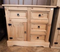 A modern pine chest of four short drawers, with cupboard raised on bracket feet,