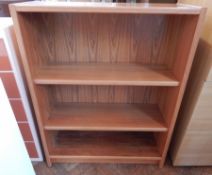 A modern teak open bookcase of three shelves,