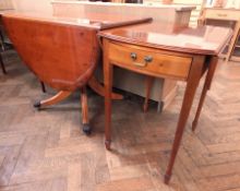 A teak drop-leaf table on cabriole supports and claw castors,