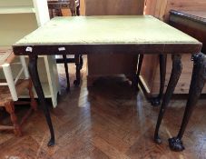 An old square-top card table lined with green baize on cabriole legs,