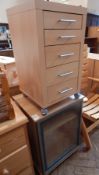 A melamine cabinet with five graduating drawers,