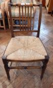 A Victorian oak chair, rush seated, railback,